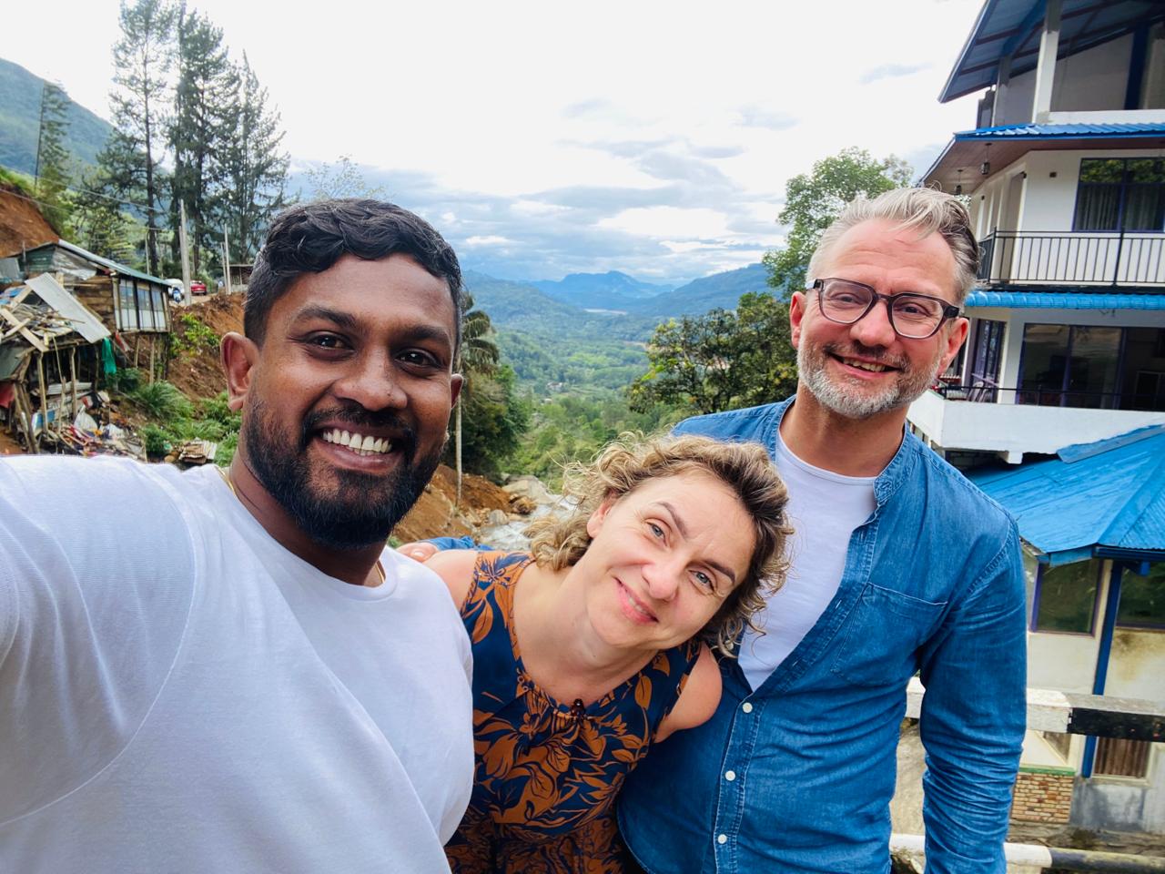 Kanishka with two guests in the Sri Lankan hill country, mountains in the background