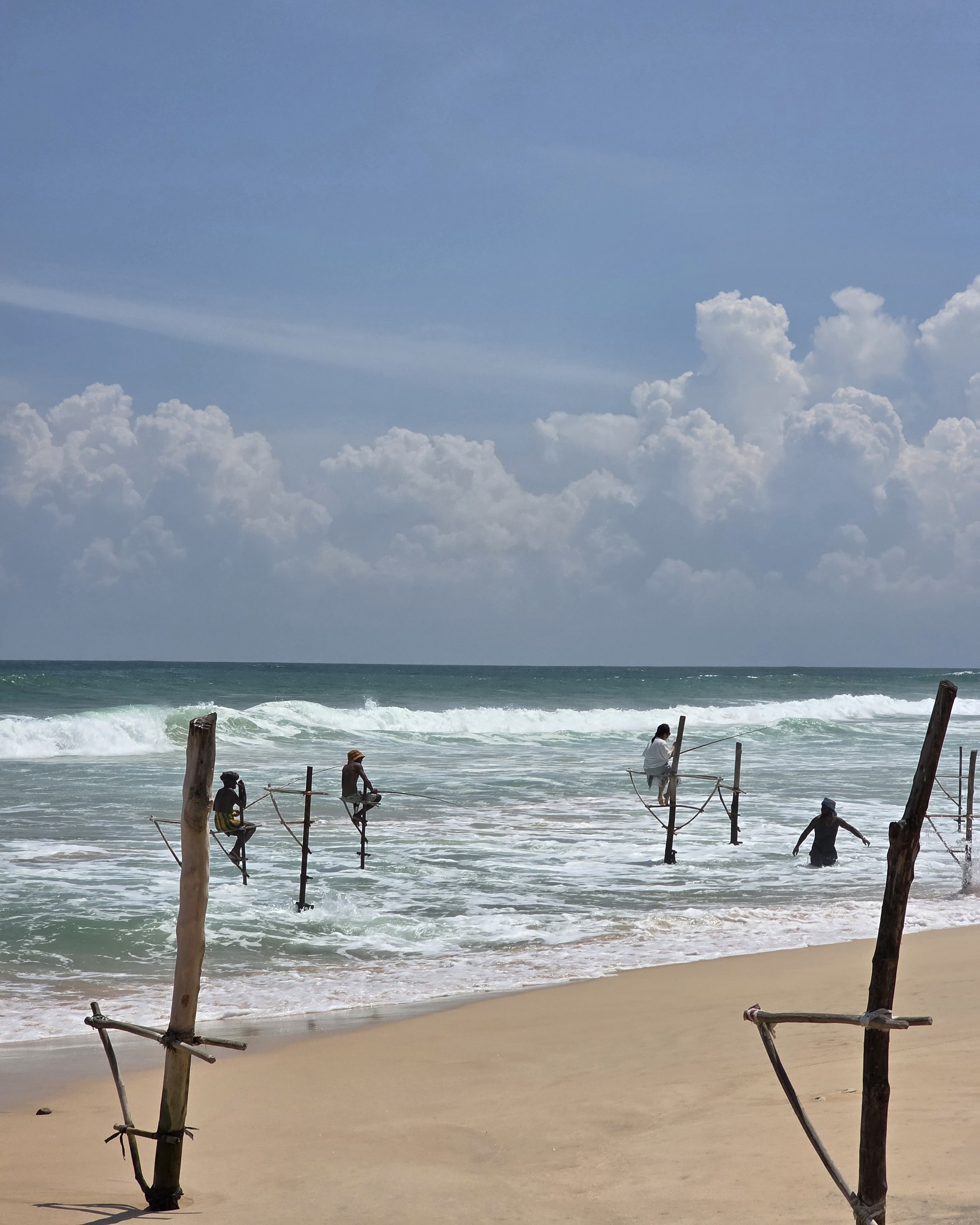 A stilt fisherman balanced on his pole above the sea at Ahangama, Sri Lanka